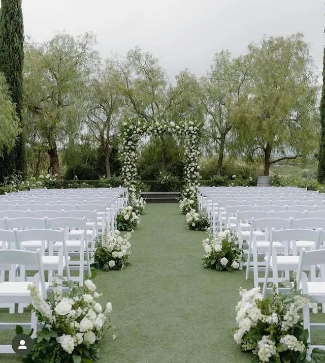outdoor ceremony aisle decor with floral arrangements