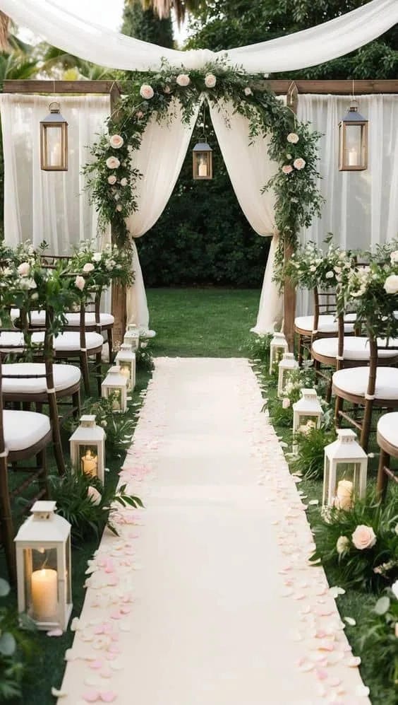 wedding aisle decor with lanterns petals and greenery