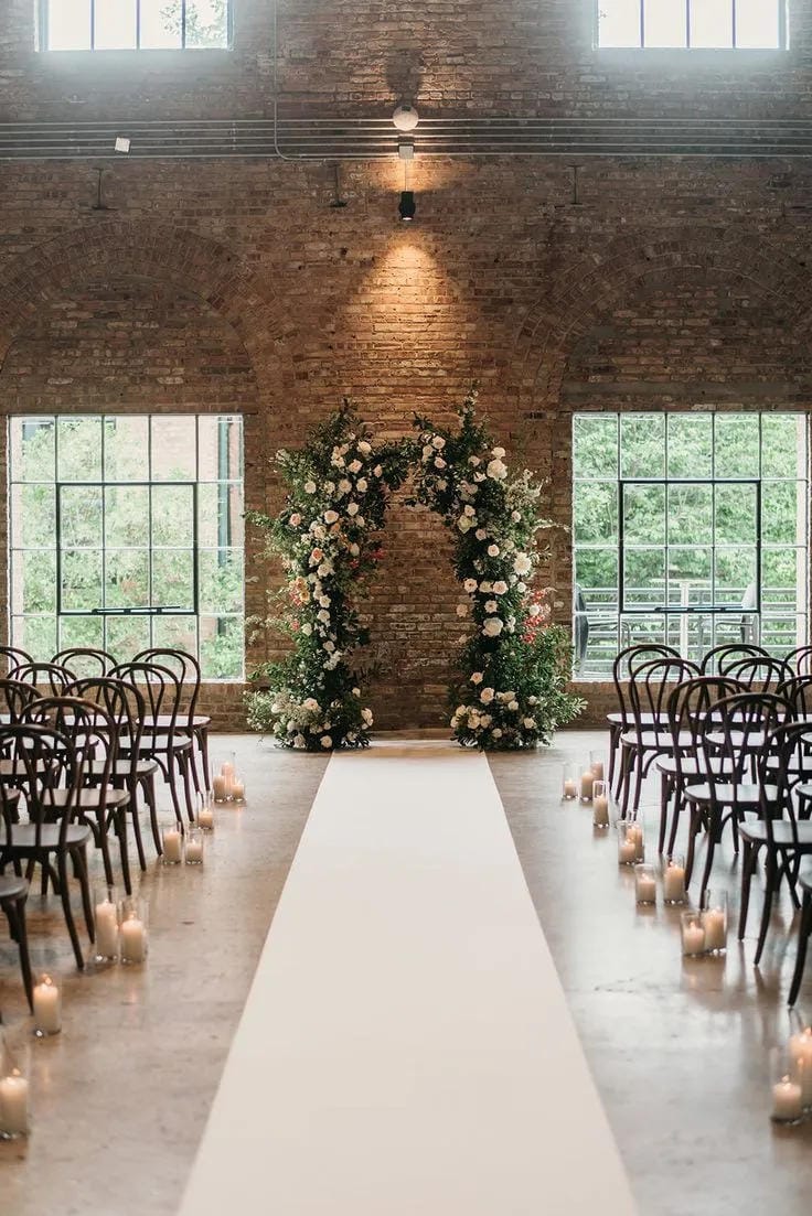 wedding ceremony aisle flowers with elegant white details