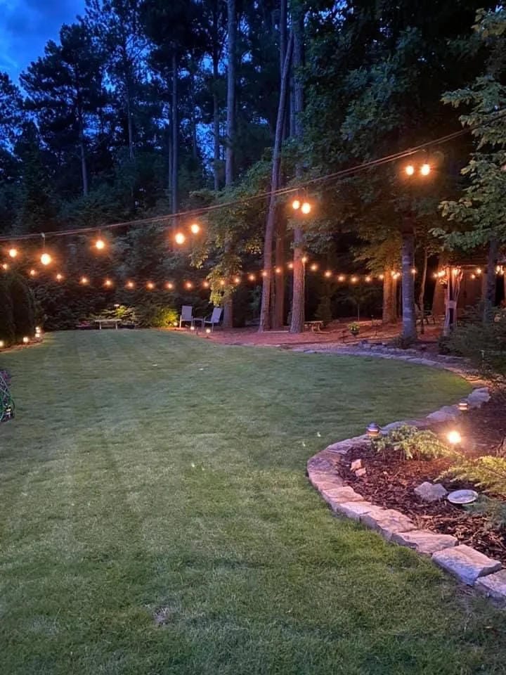 outdoor string light ideas with run lights along a wide lawn