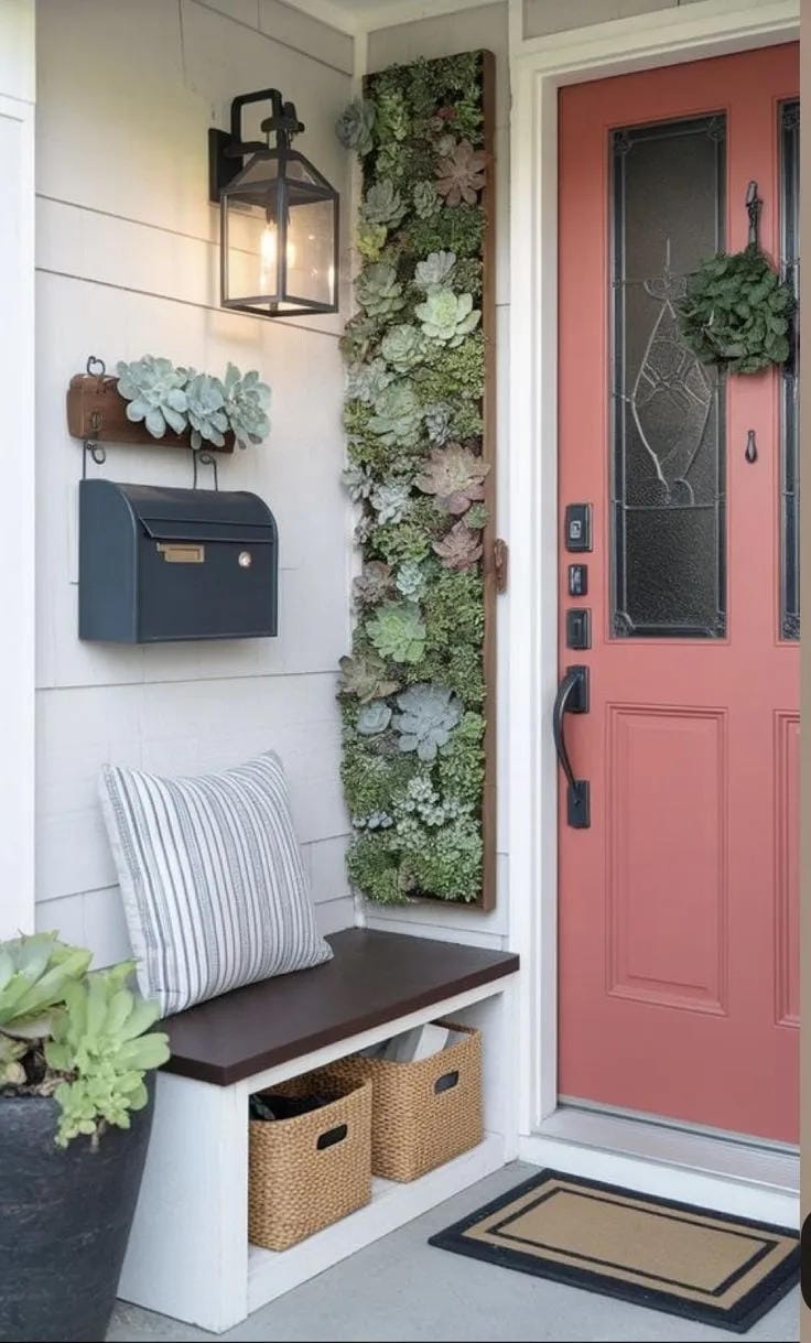 small front porch decorating idea with coral door bench wall flowers and storage baskets
