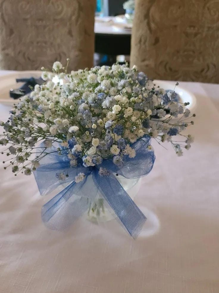 boy baby shower centerpiece with blue bow and baby breath