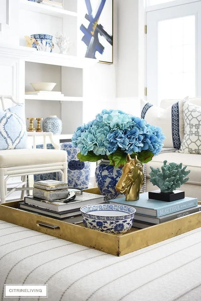 summer living room coffee table with books and flowers
