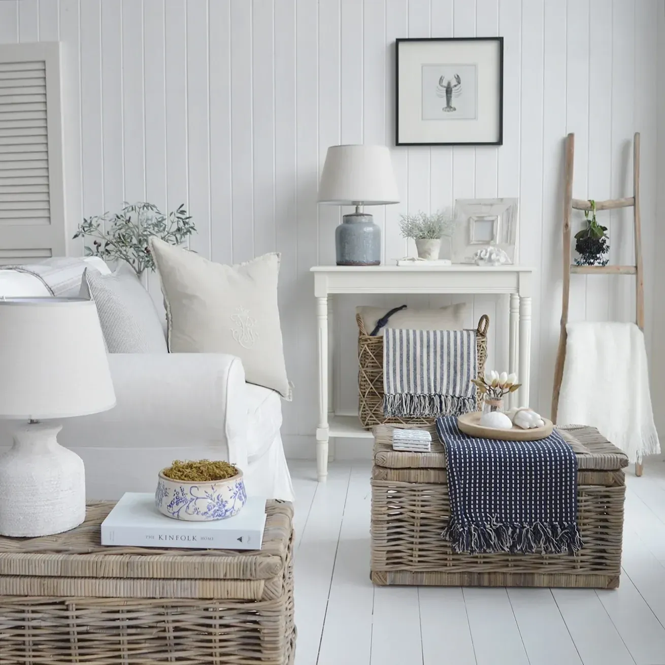 blue and white coastal living room ideas with fireplace, blue ottoman, and woven baskets