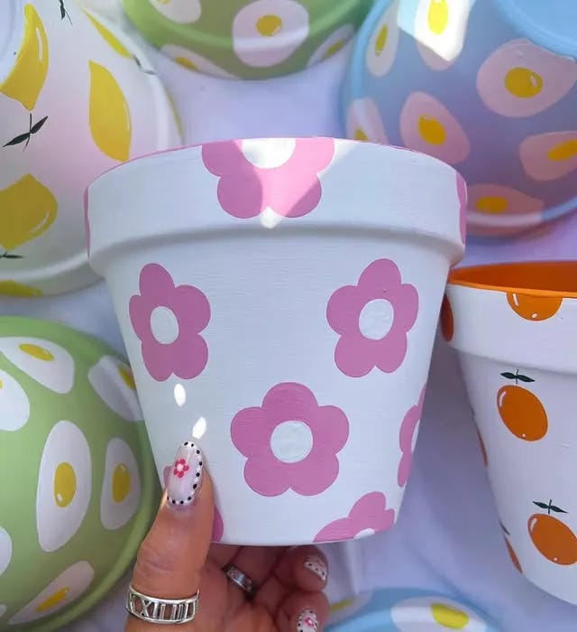 painted flower pot idea with pink retro flowers and white base