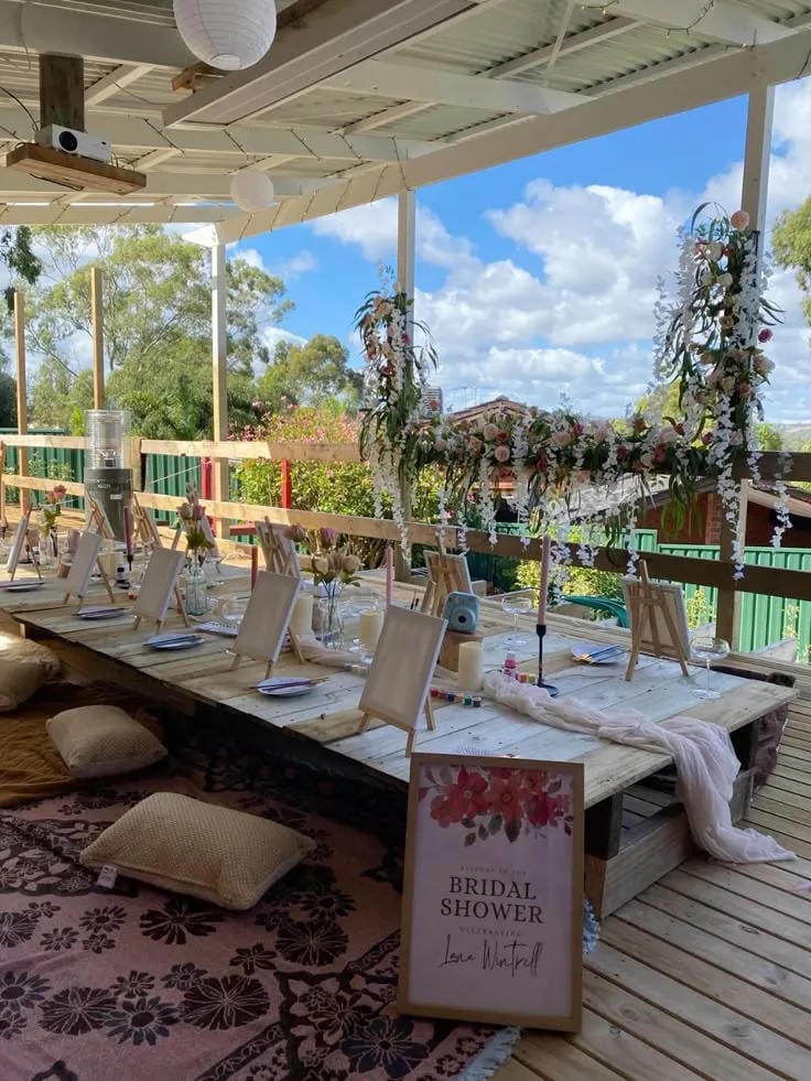 garden bridal shower painting activity with easels and flowers