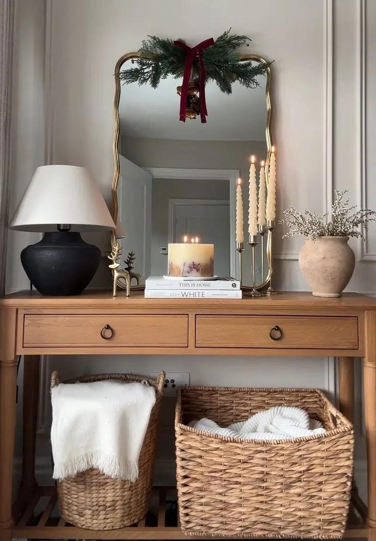 christmas entryway table decor with mirror wreath lamp basket and candles