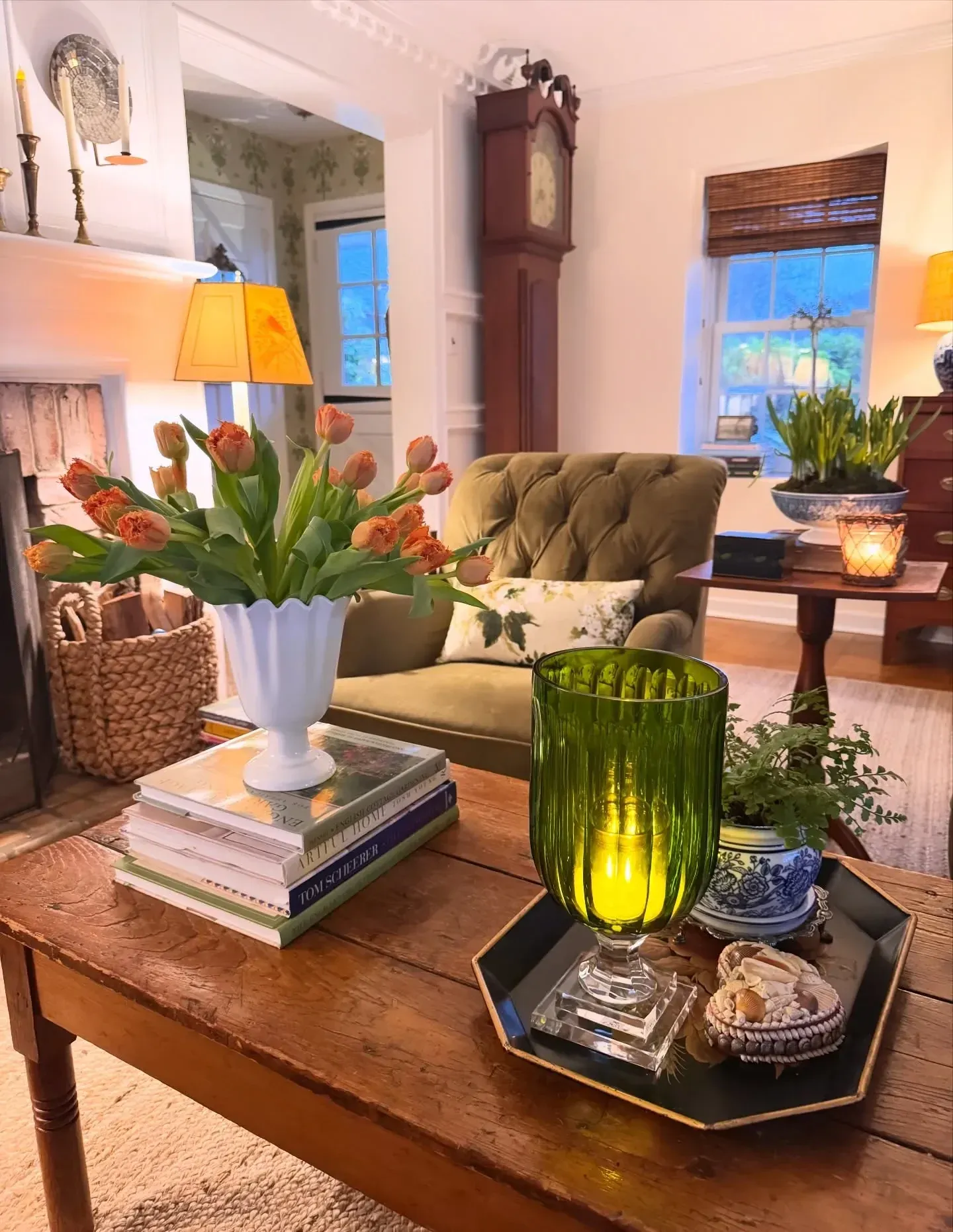 thrifted vintage home decor ideas with green glass, books, tray, flowers, and coffee table styling