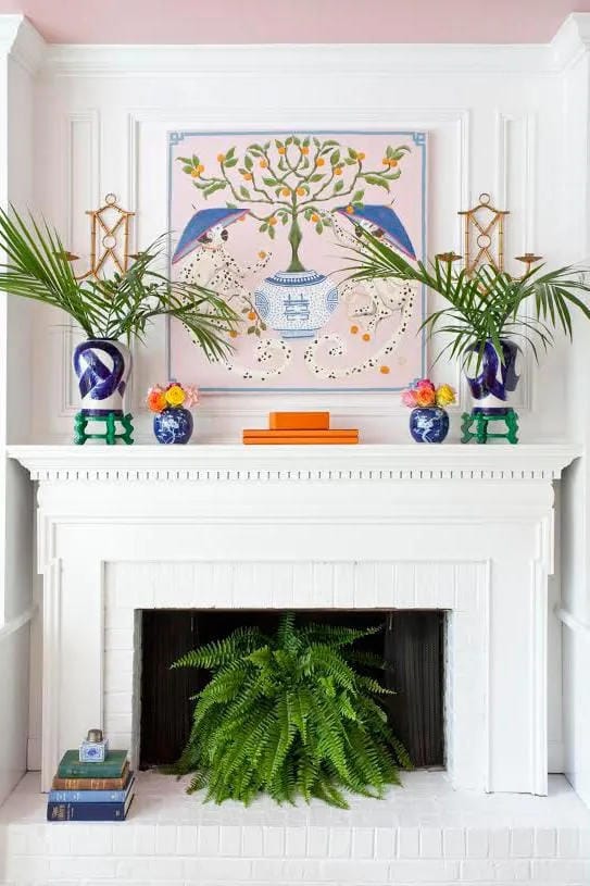summer mantel decor ideas with use palm leaves beside colorful art