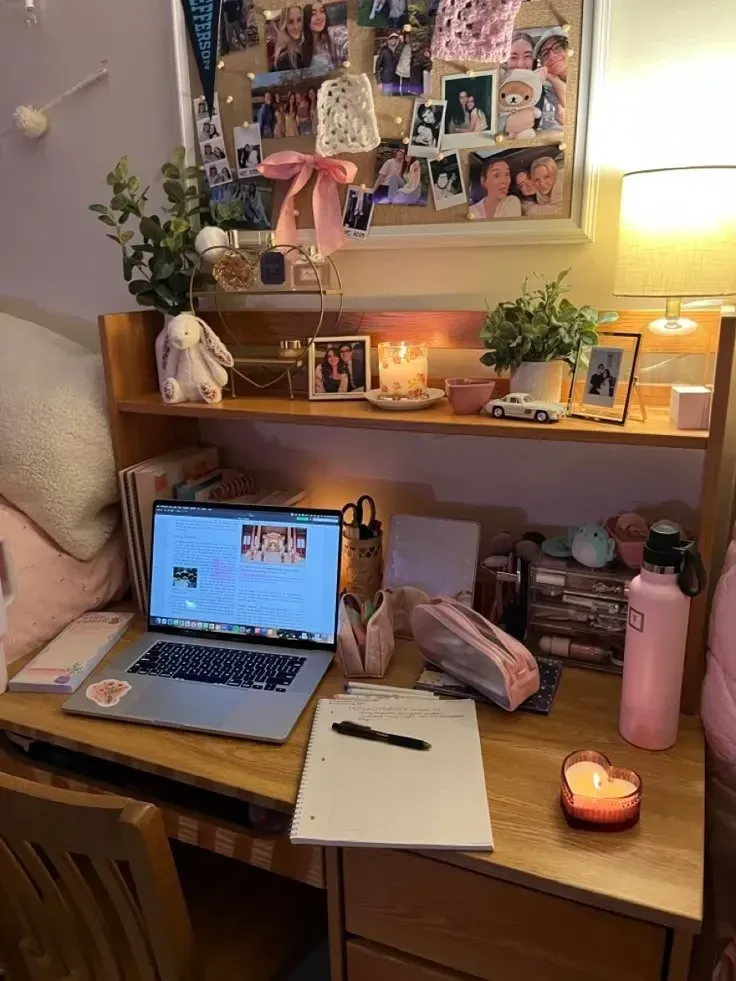 dorm desk ideas with a photo board shelf lamp laptop and warm lighting