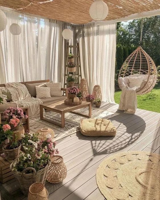 covered porch ideas with white curtains hanging egg chair wicker seating and flowers