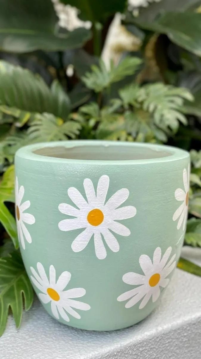 painted flower pot idea with sage green base and white daisy flowers
