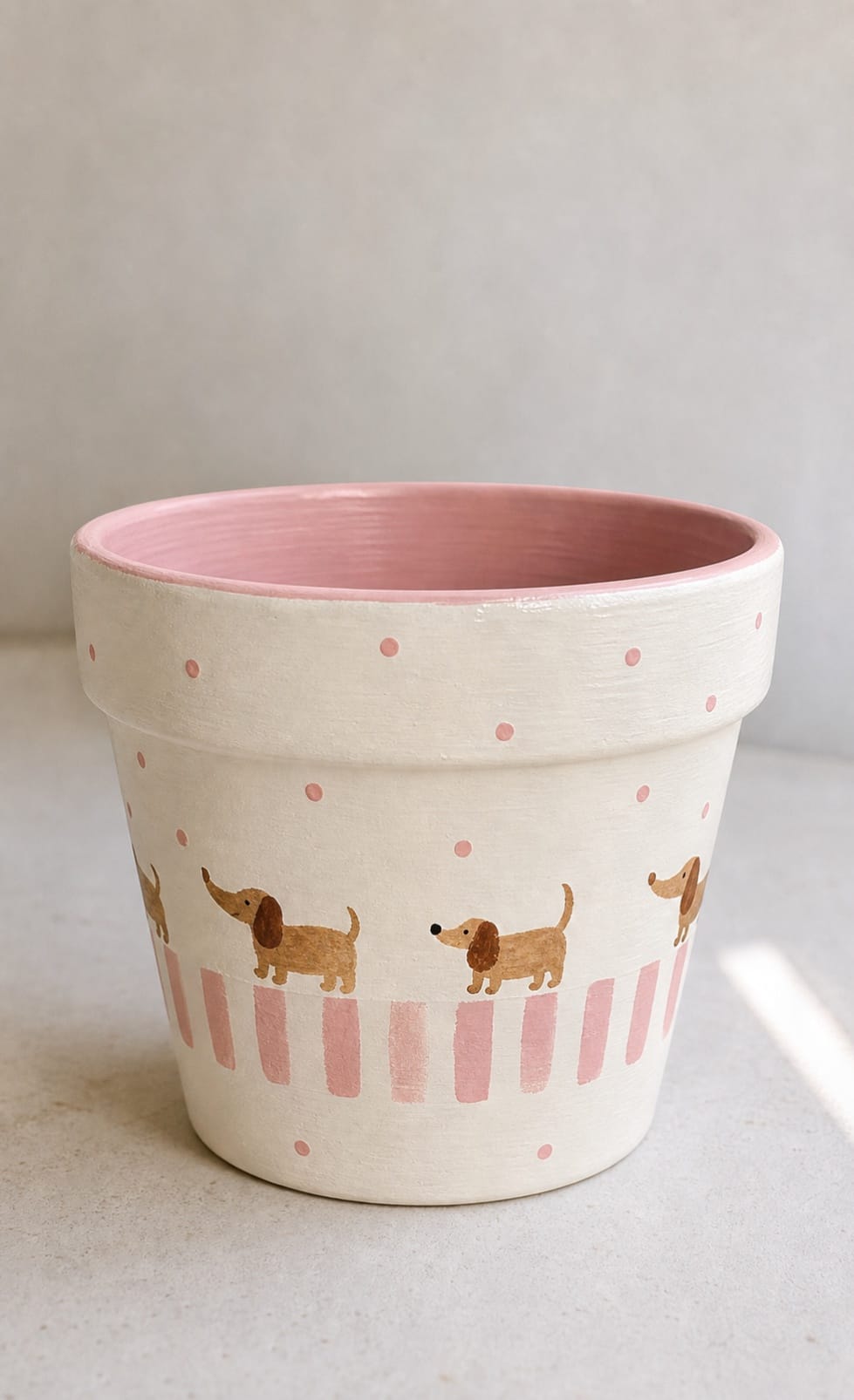 painted flower pot with tiny sausage dog border and pink striped base