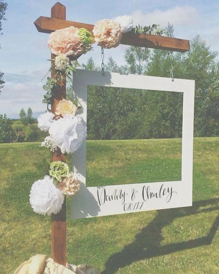 outdoor bridal shower table setup with flowers and candles