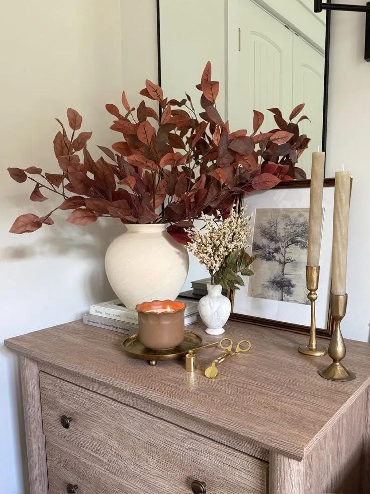 fall nightstand decor ideas with red branches candle taper candles and framed art