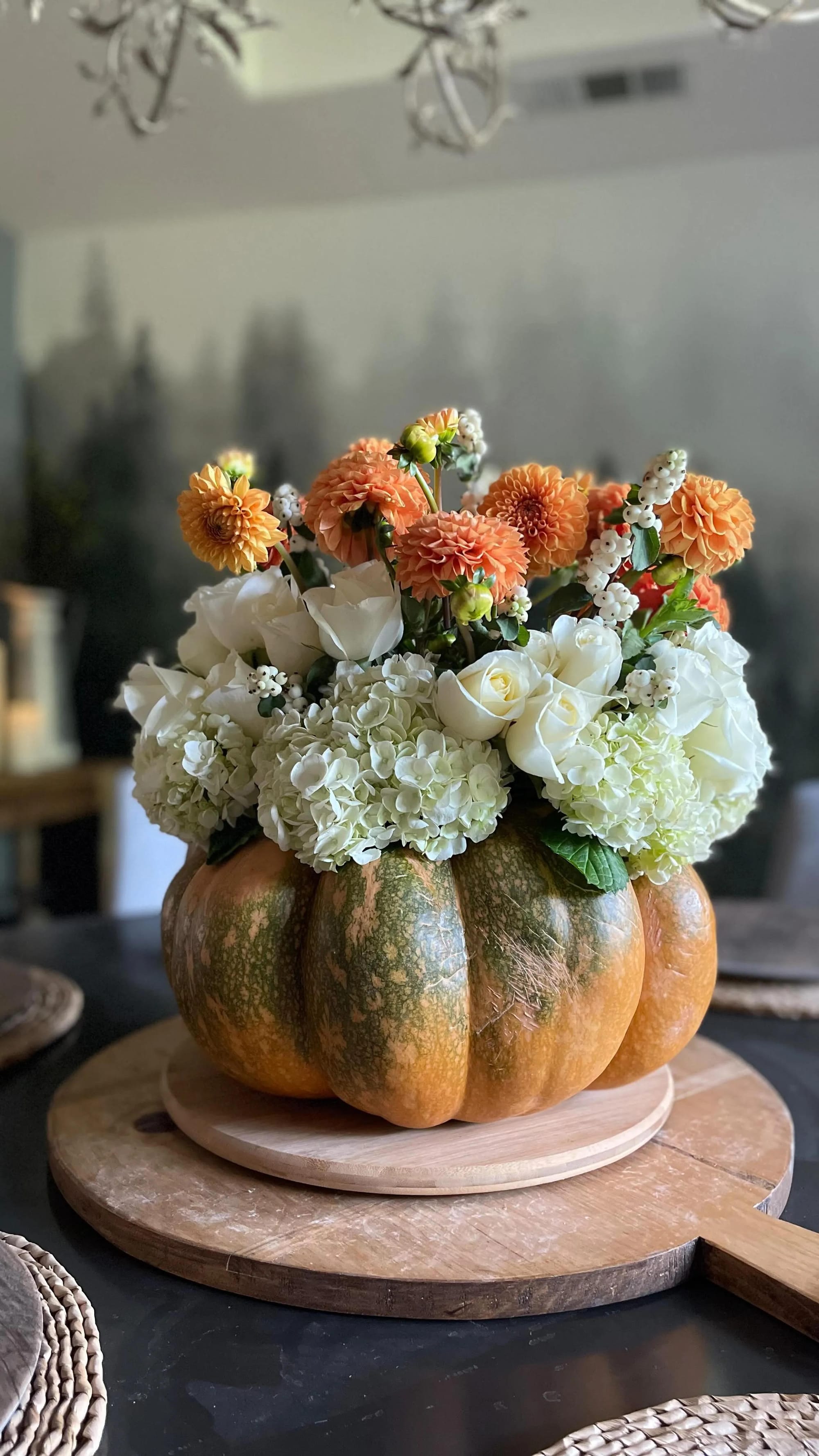 fall flower arrangement ideas with white hydrangeas orange flowers and a pumpkin vase