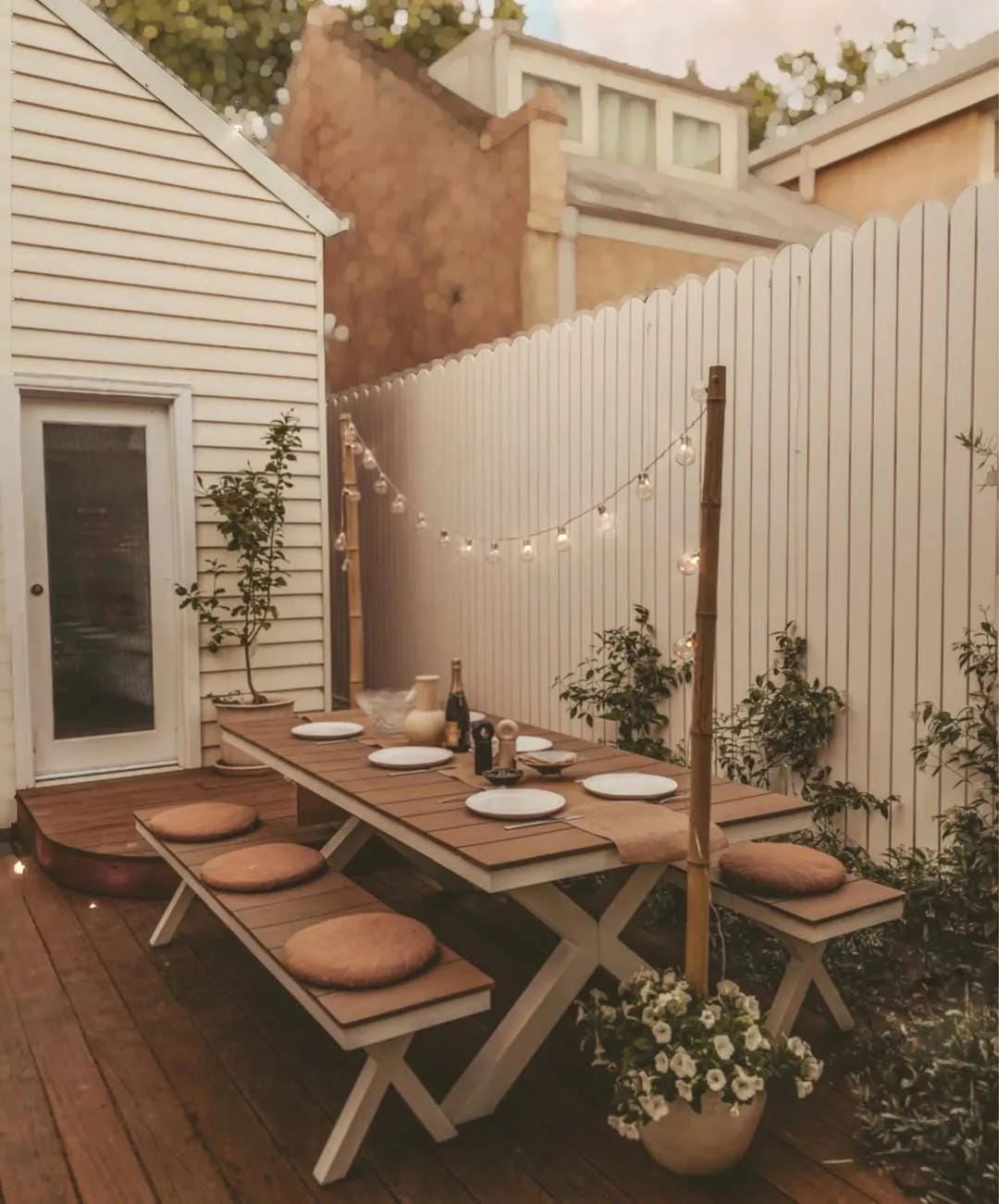 outdoor string light ideas with string lights over a fence table