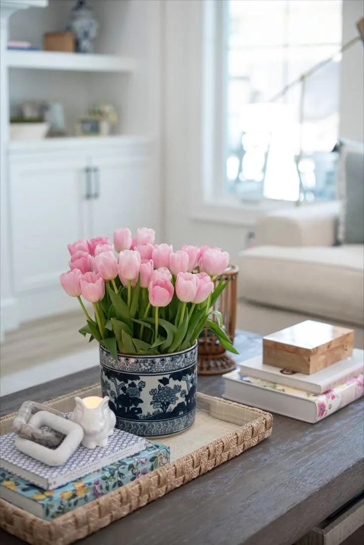 summer coffee table centerpiece with flowers and woven tray