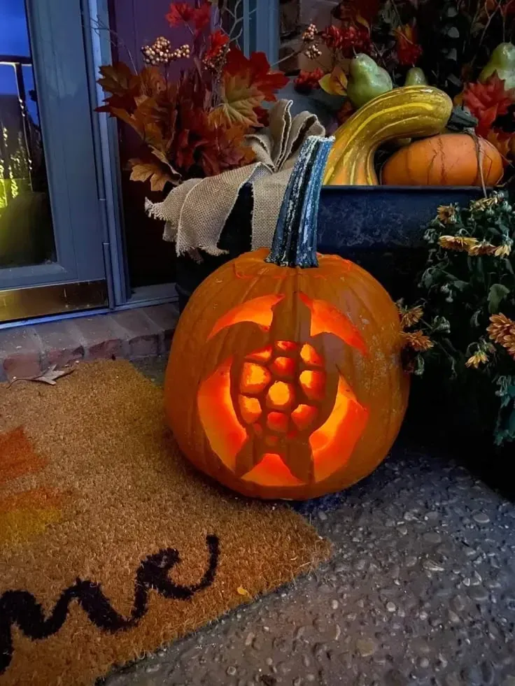 kid friendly pumpkin carving ideas with flower cutouts, glowing pumpkin, and cheerful fall porch design