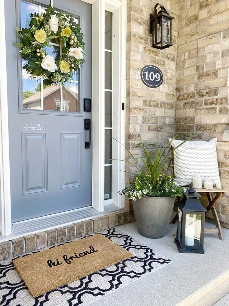 tiny front porch design with flowers and door decor
