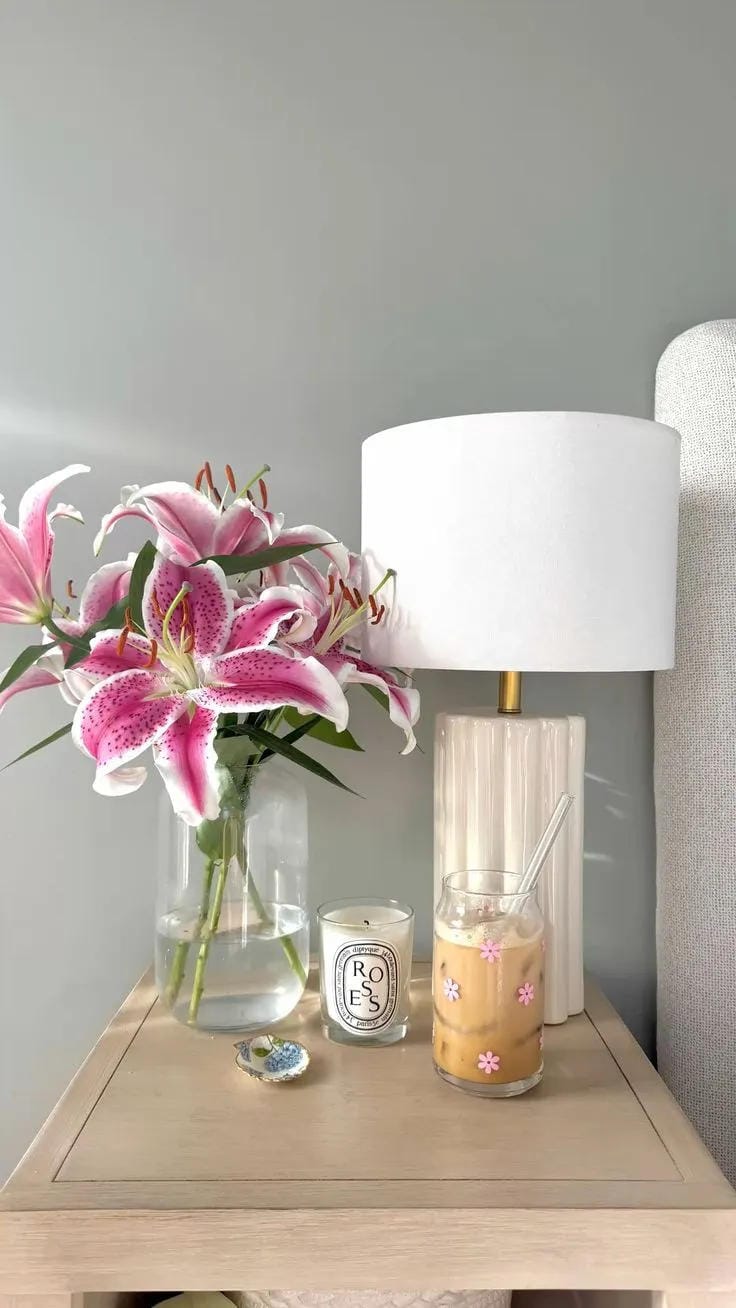 nightstand decor ideas with glass lamp pink lilies candle and bedside table
