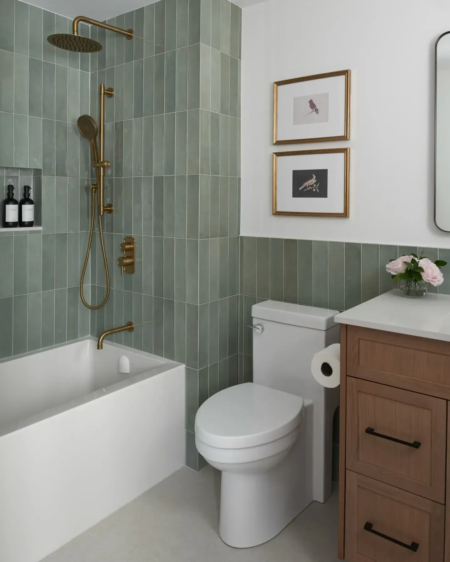 green bathroom ideas with sage shower tile, bathtub, glass screen, wood vanity, and framed art