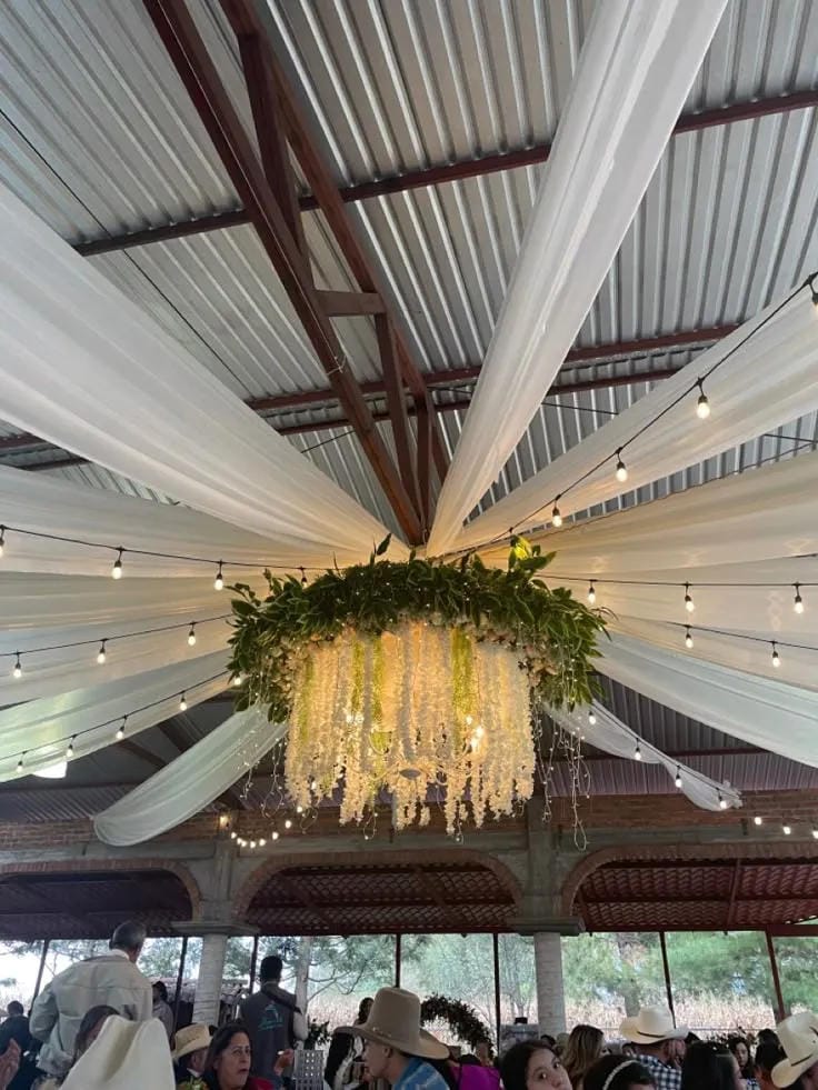 wedding aisle idea with flower arrangements along the chairs