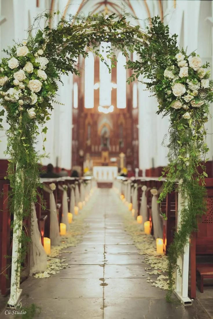romantic wedding aisle styling with candles and blooms