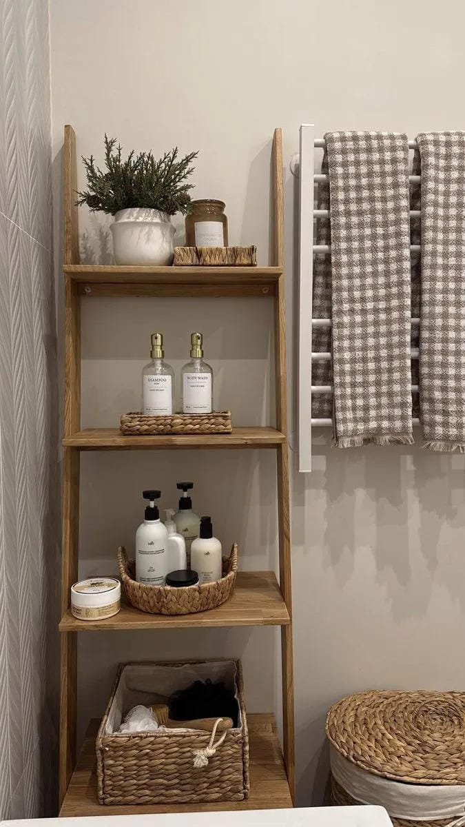 bathroom ladder shelf decor with towels bottles baskets plants and checked hand towel