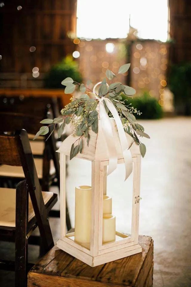 DIY wedding table arrangement with greenery and neutral decor