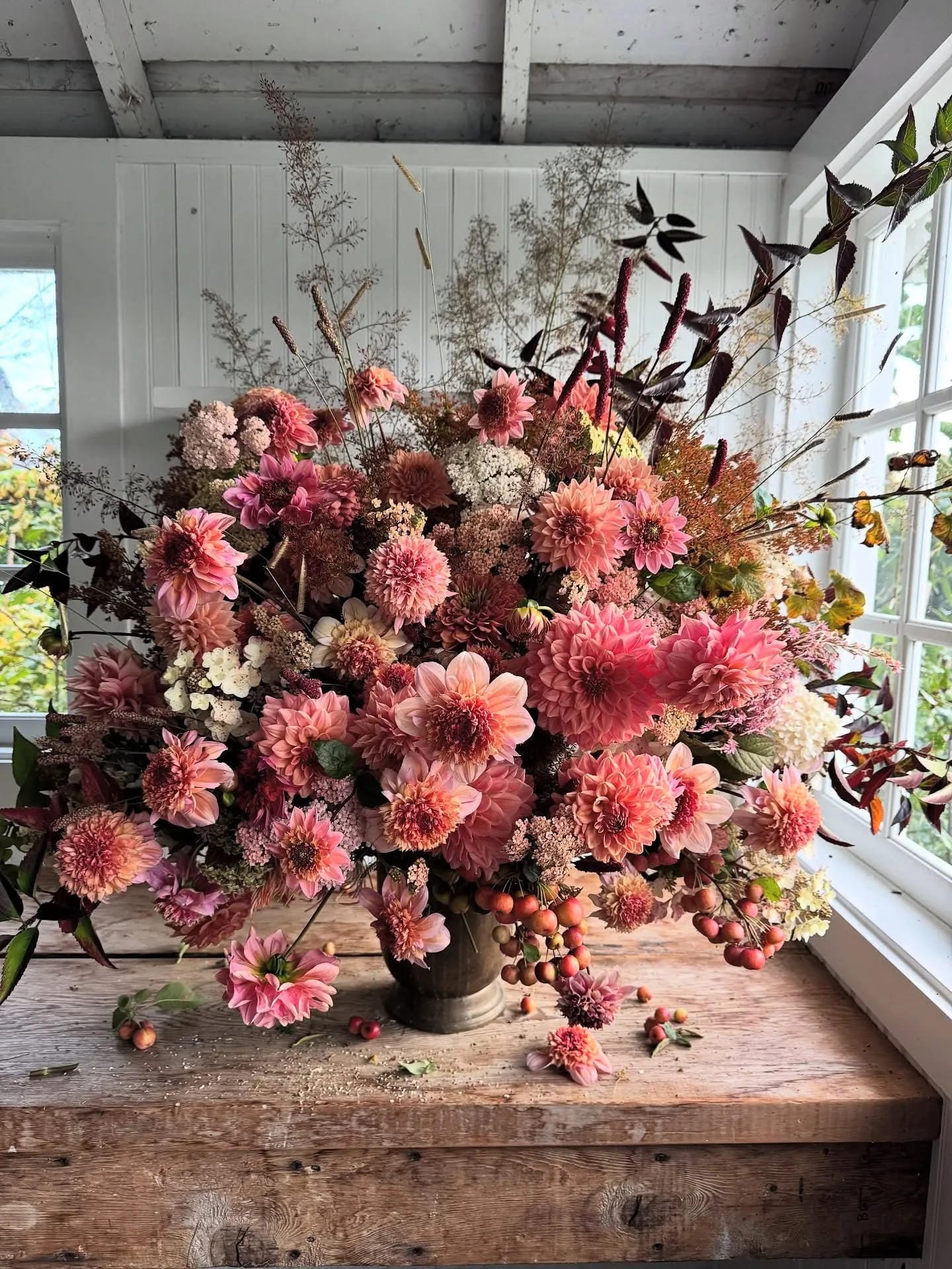 fall flower arrangement ideas with a large pink dahlia arrangement and dark stems