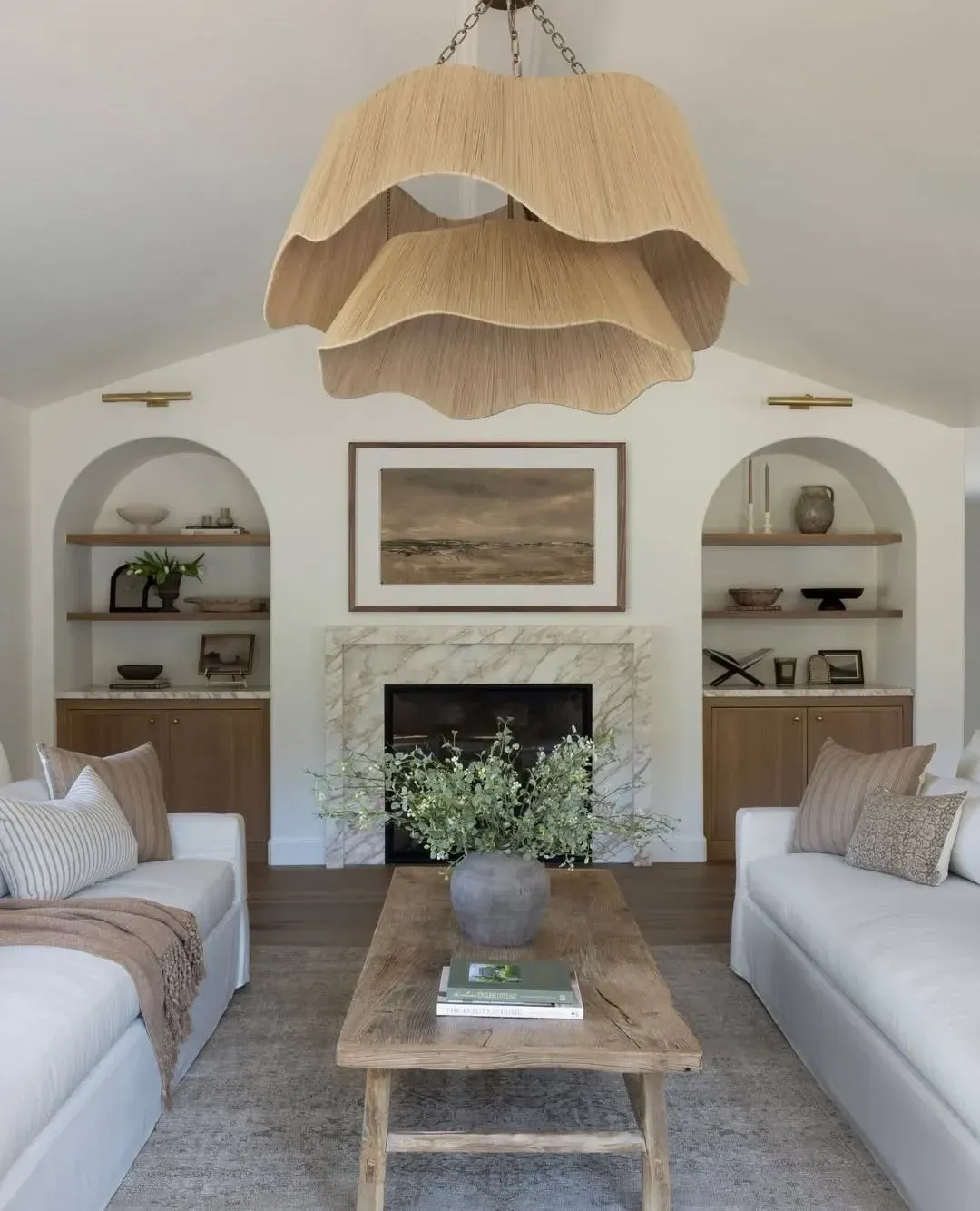 neutral coastal living room ideas with shell pendant, built-ins, white sofas, and fireplace