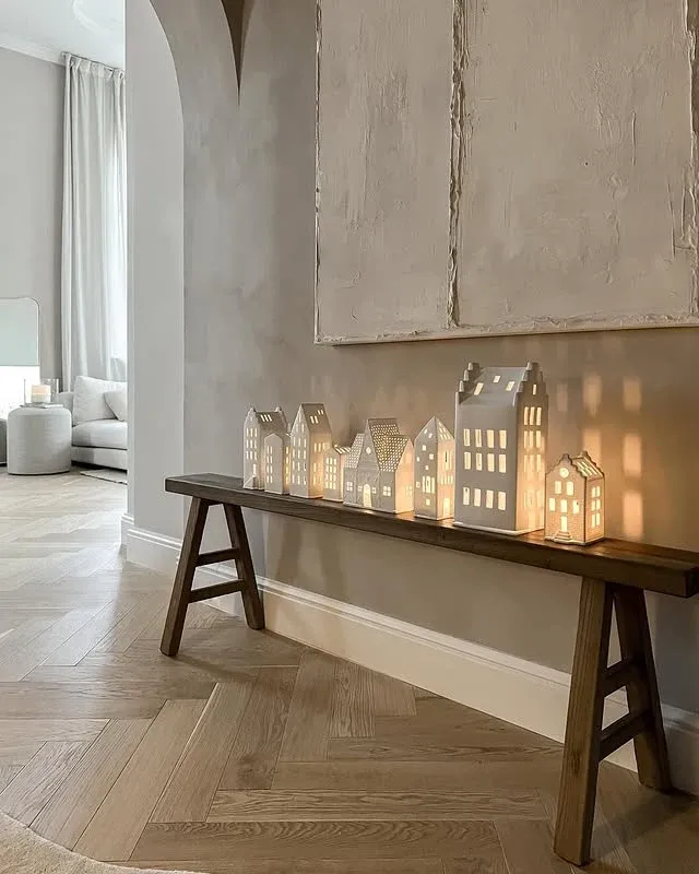 Illuminated paper houses on a sideboard for Scandinavian Christmas decor
