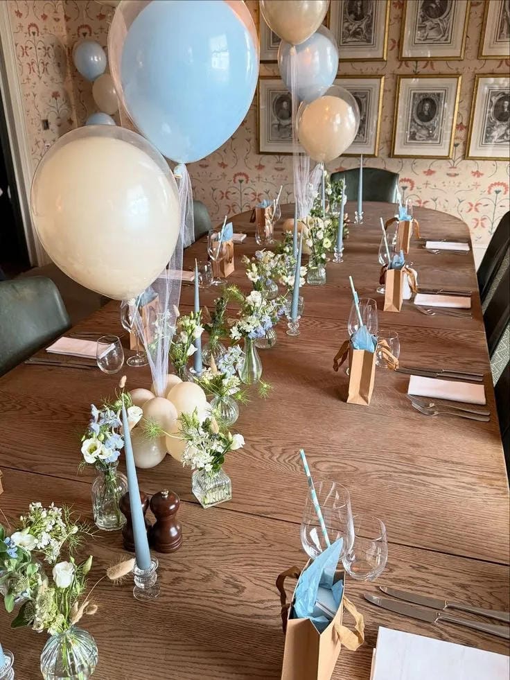 boy baby shower long table with greenery and blue balloons