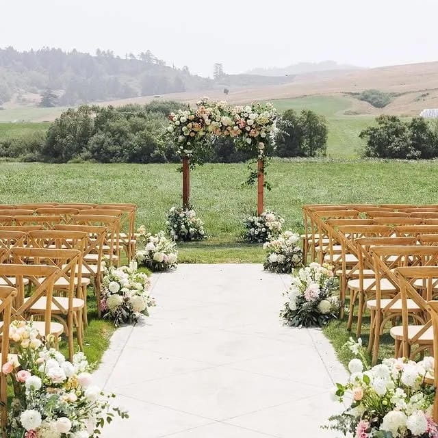 romantic outdoor wedding aisle setup with blooms