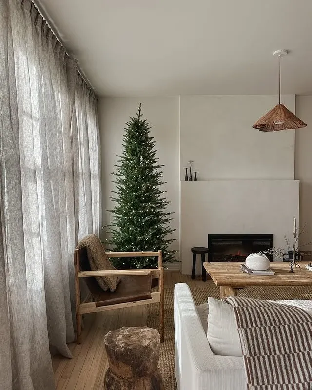Minimal Scandinavian living room with a Christmas tree for Scandinavian Christmas decor