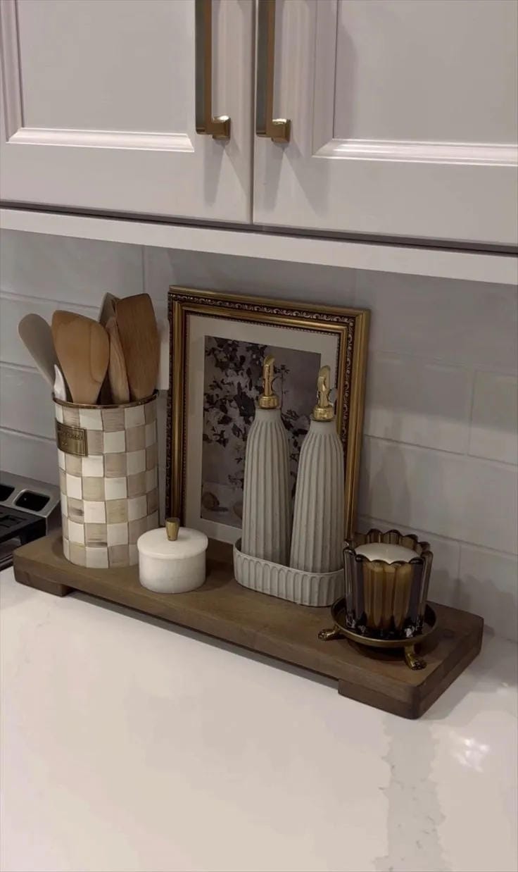 kitchen counter decor ideas with narrow wood shelf utensils candle and framed art