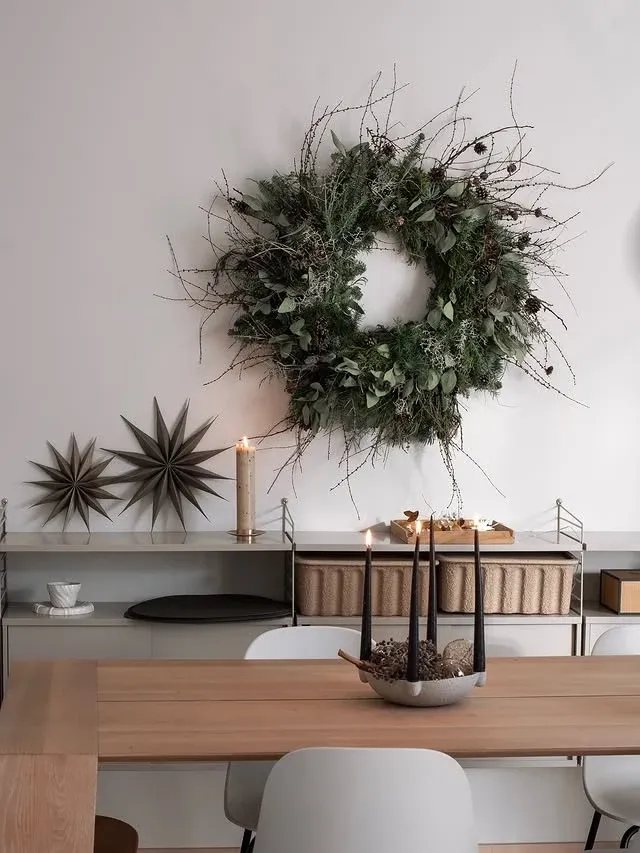 Natural Christmas wreath above a sideboard for Scandinavian Christmas decor