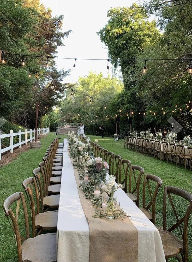 wedding centerpiece with wood slices candles and greenery