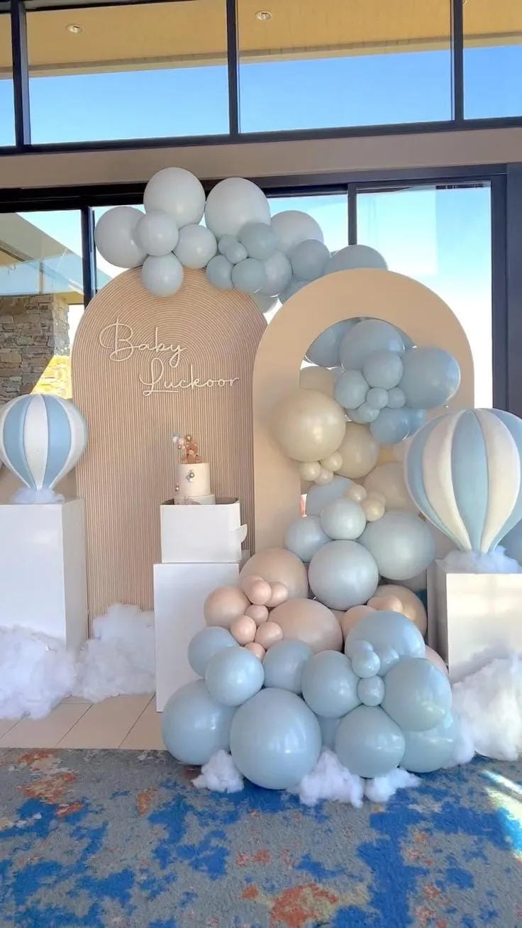boy baby shower cake display with pale blue balloons
