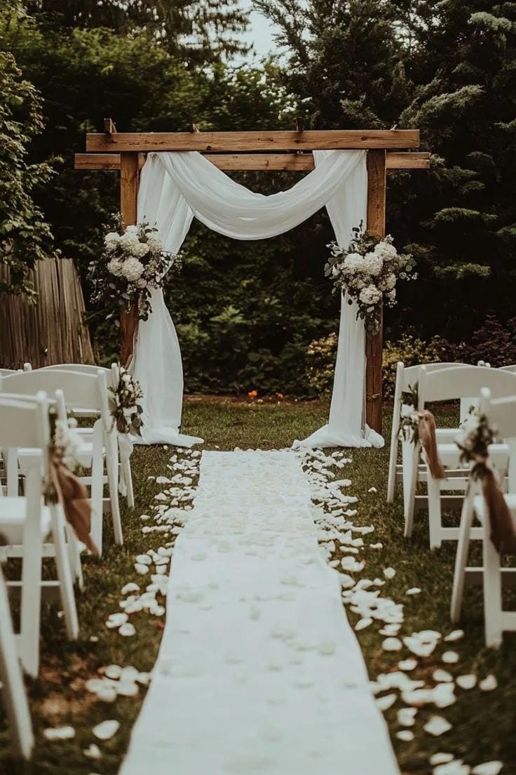 wedding aisle decor idea with white petals and chairs