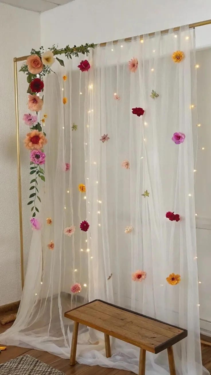 bridal shower floral photo backdrop with lights and white curtain