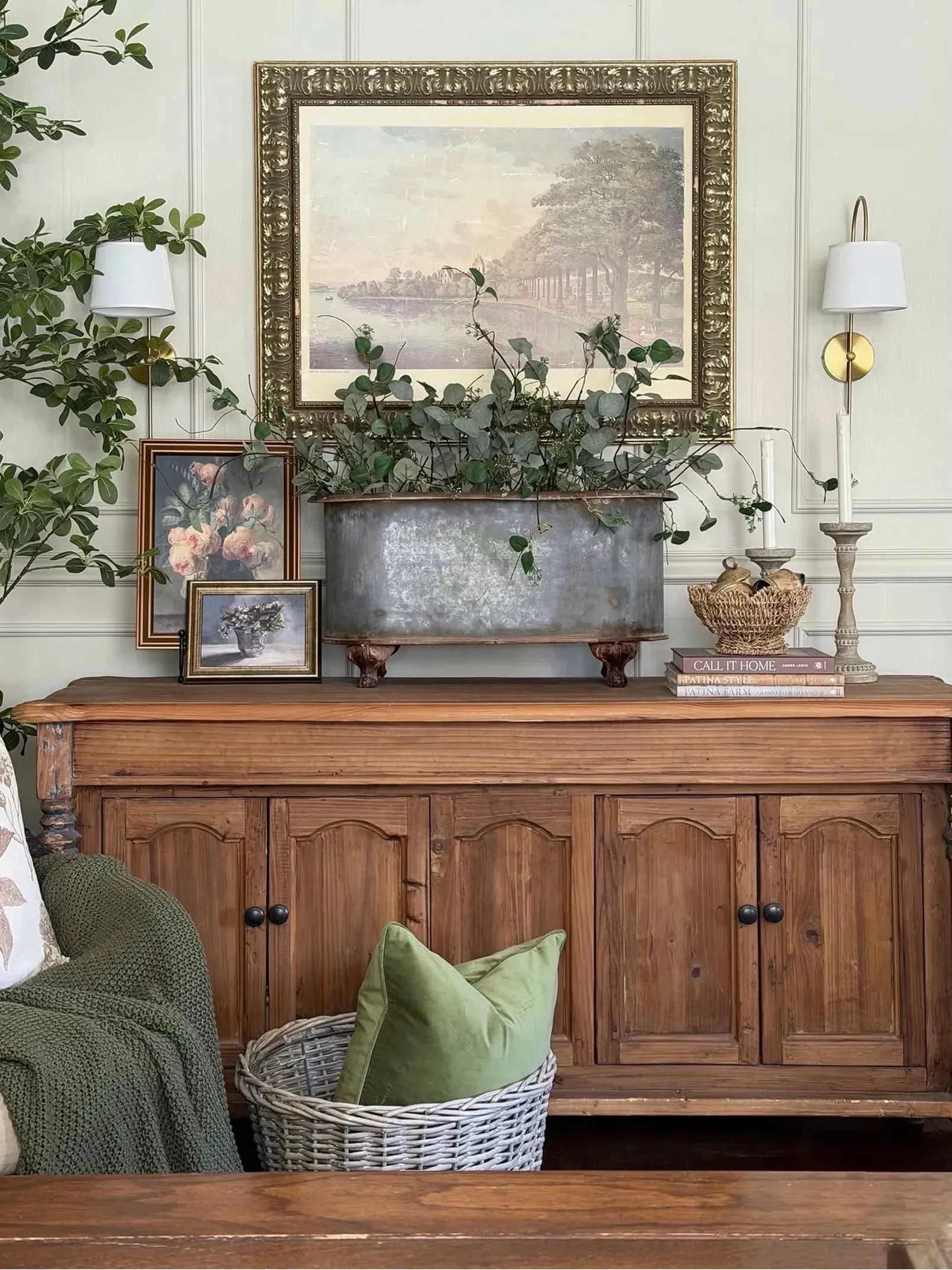 colorful vintage home decor ideas with wood cabinet, landscape art, green pillows, and flowers