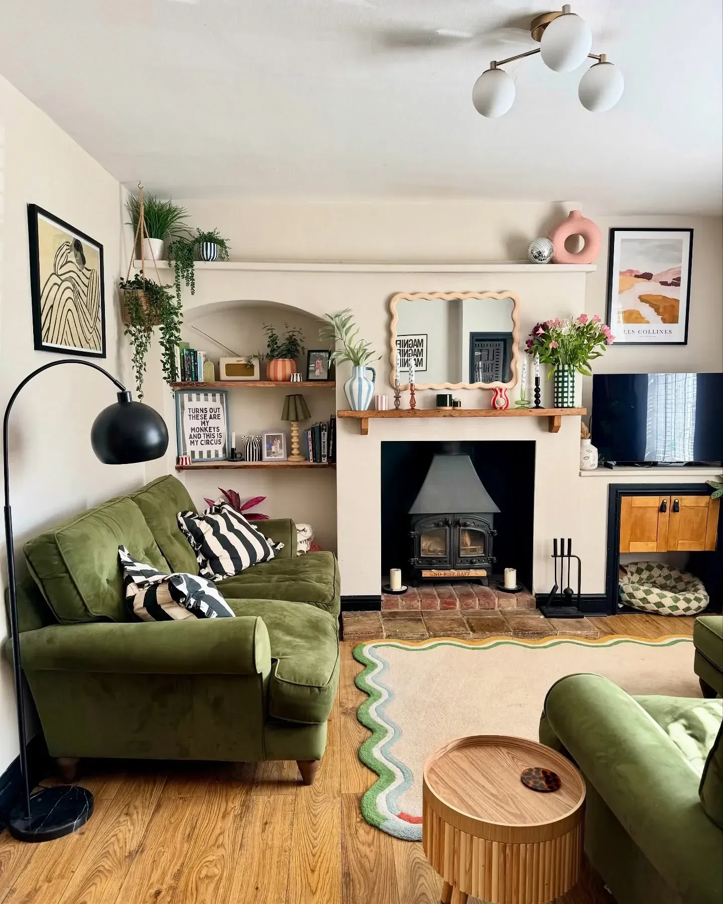 colorful living room ideas with green sofas, fireplace, black and white pillows, plants, and colorful decor