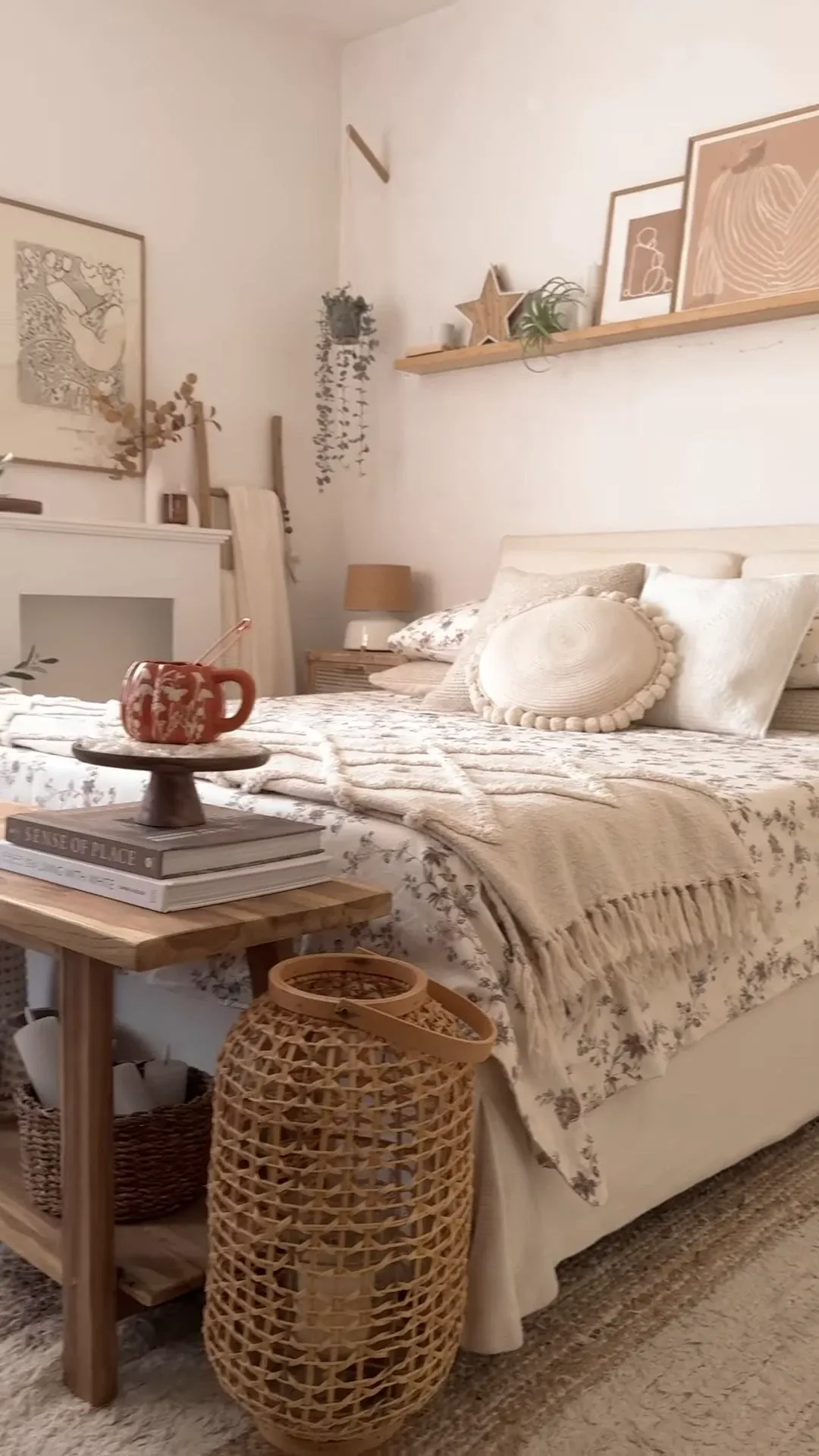 fall bedroom ideas with pumpkin mug, floral bedding, woven lantern, soft pillows, neutral decor, and cozy bedroom corner