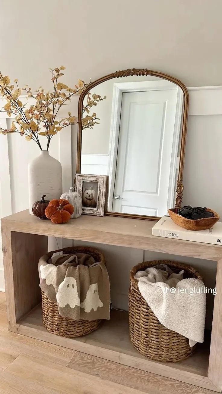 fall entryway table decor with pumpkins mirror branches and baskets