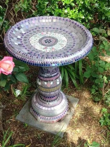DIY bird bath idea with purple mosaic tiles and garden pedestal