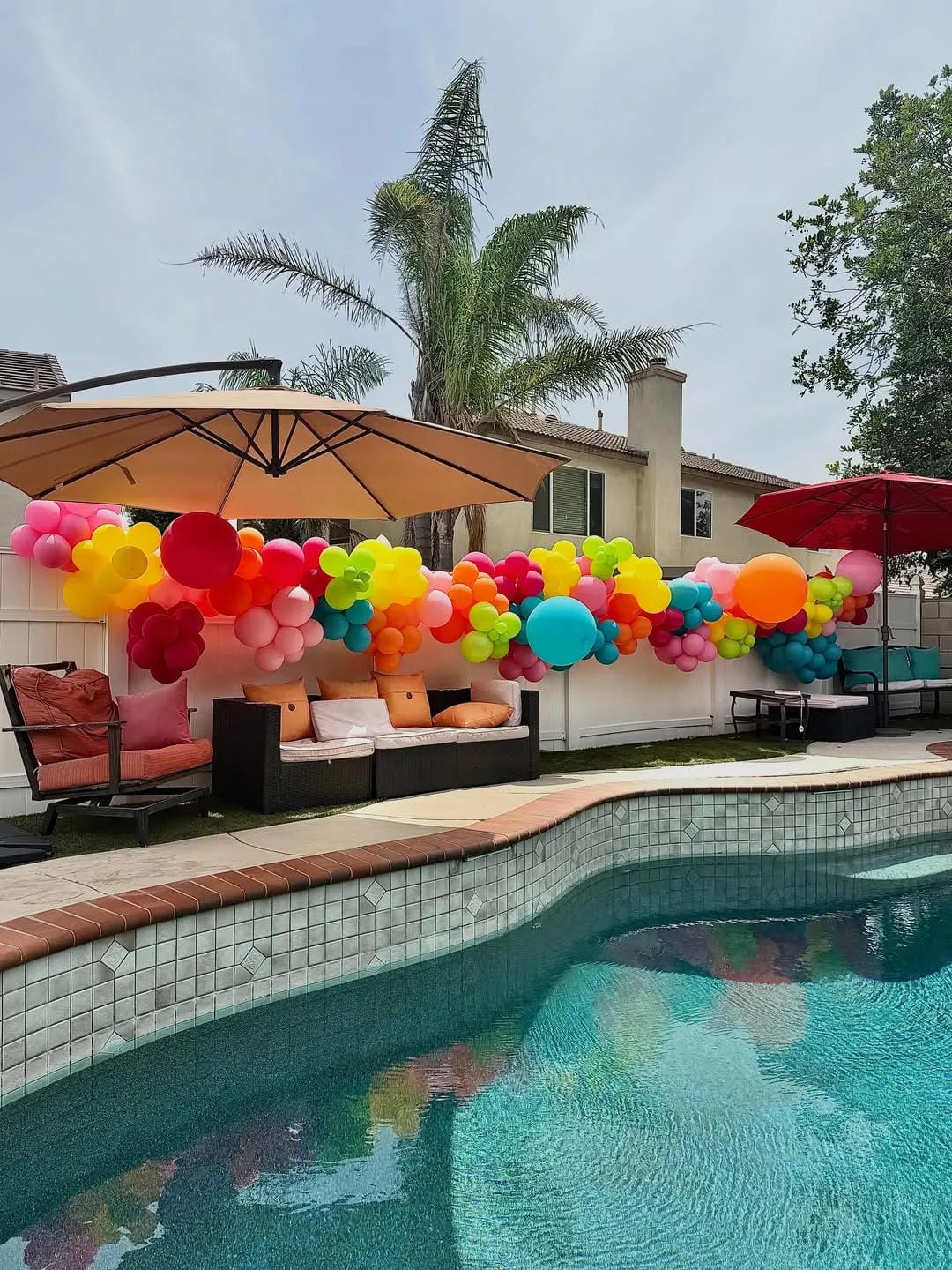 pool party decor ideas with run rainbow balloons along the pool edge