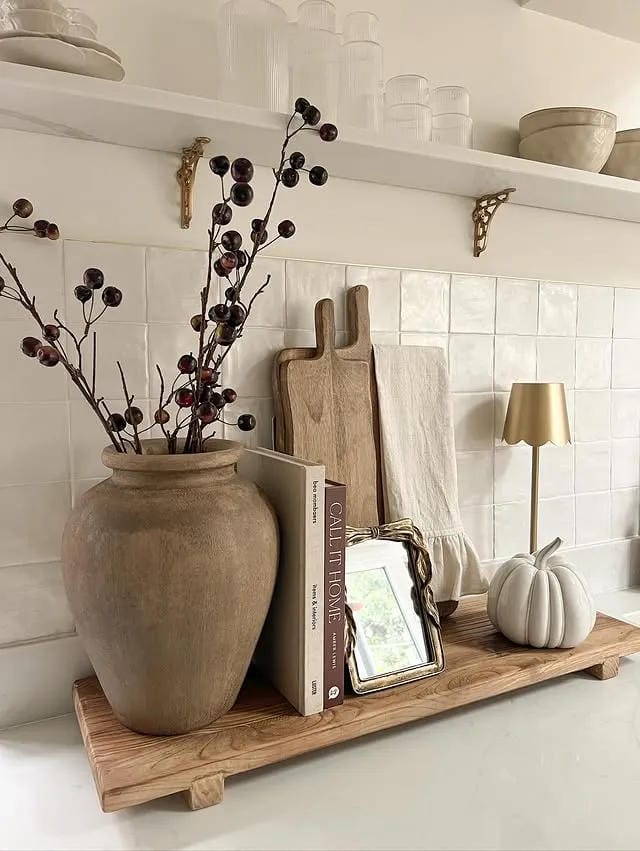 kitchen counter decor ideas with rustic wood board vase branches books and pumpkin
