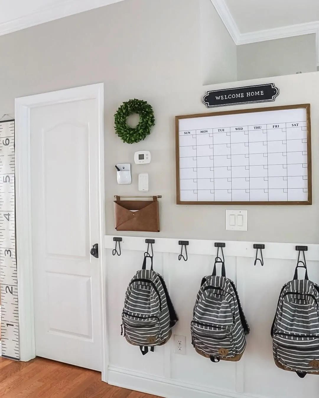 back to school entryway ideas with backpack hooks and storage bench